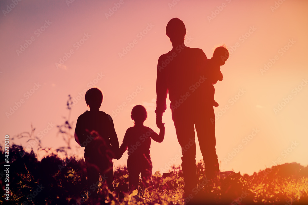 father with tree kids walk in sunset nature
