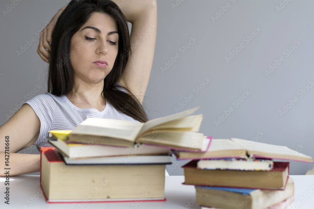 tired and sad student woman with books worried about exams tired and sad student woman with books worried about exams