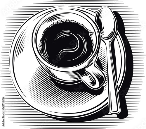 Cup of coffee with saucer and spoon.