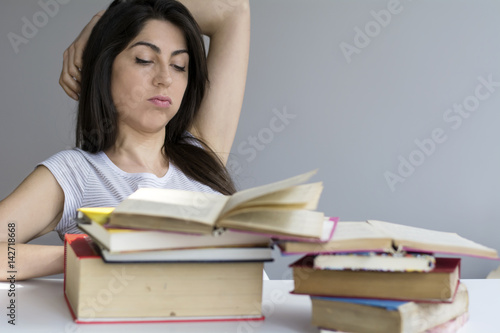 tired and sad student woman with books worried about exams