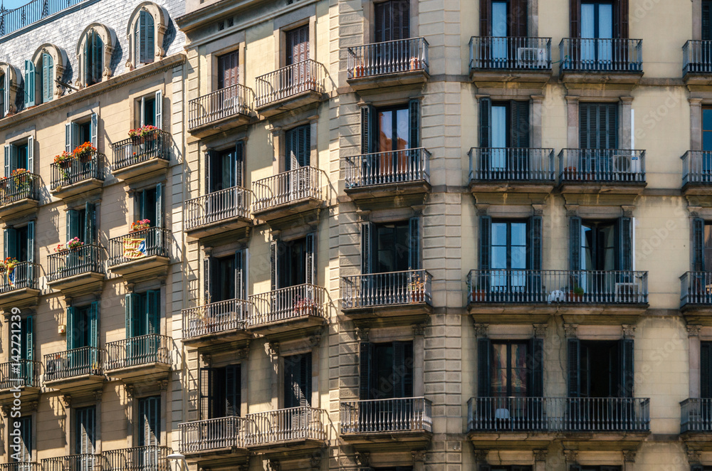 Geometric shapes of facade of modernist residential building with french balconies in Barcelona, Spain.