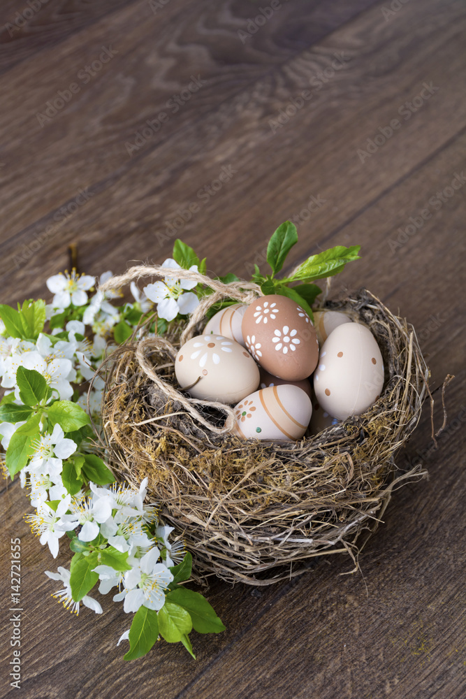 colorful easter eggs with dots in real nest with cherry blossoms on a wooden background. Easter decoration colorful easter eggs with dots in real nest with cherry blossoms on a wooden background. Easter decoration