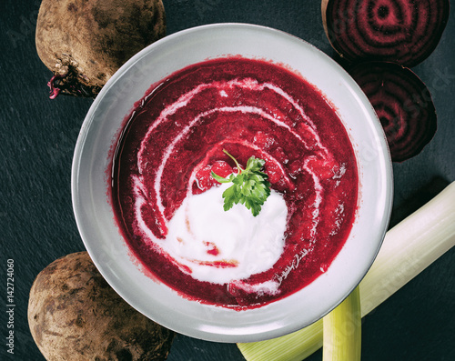 Beetroot, red borscht with sour cream and parsley photo