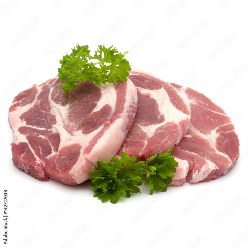 Raw pork neck chop meat with parsley herb leaves garnish isolated on white background cutout Raw pork neck chop meat with parsley herb leaves garnish isolated on white background cutout