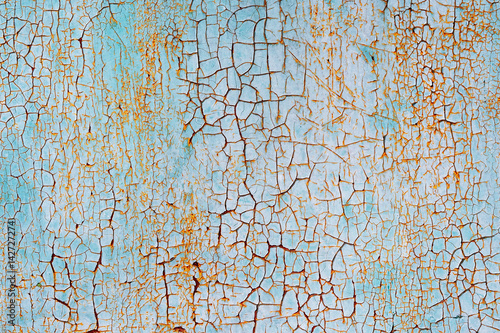 Abstract blue orange white texture with grunge cracks. Cracked paint on a metal surface. Bright urban background with rough paint transitions. Painted water color colored texture 