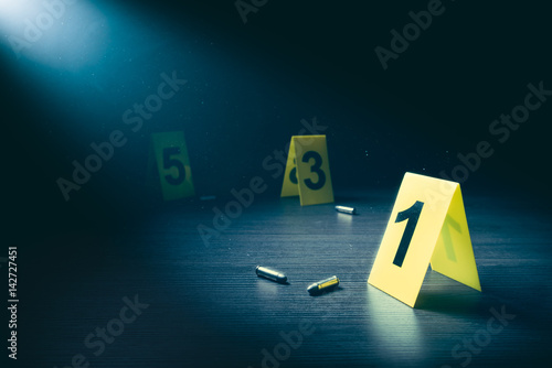 Tableau sur toile Crime scene with evidence markers on a dark background