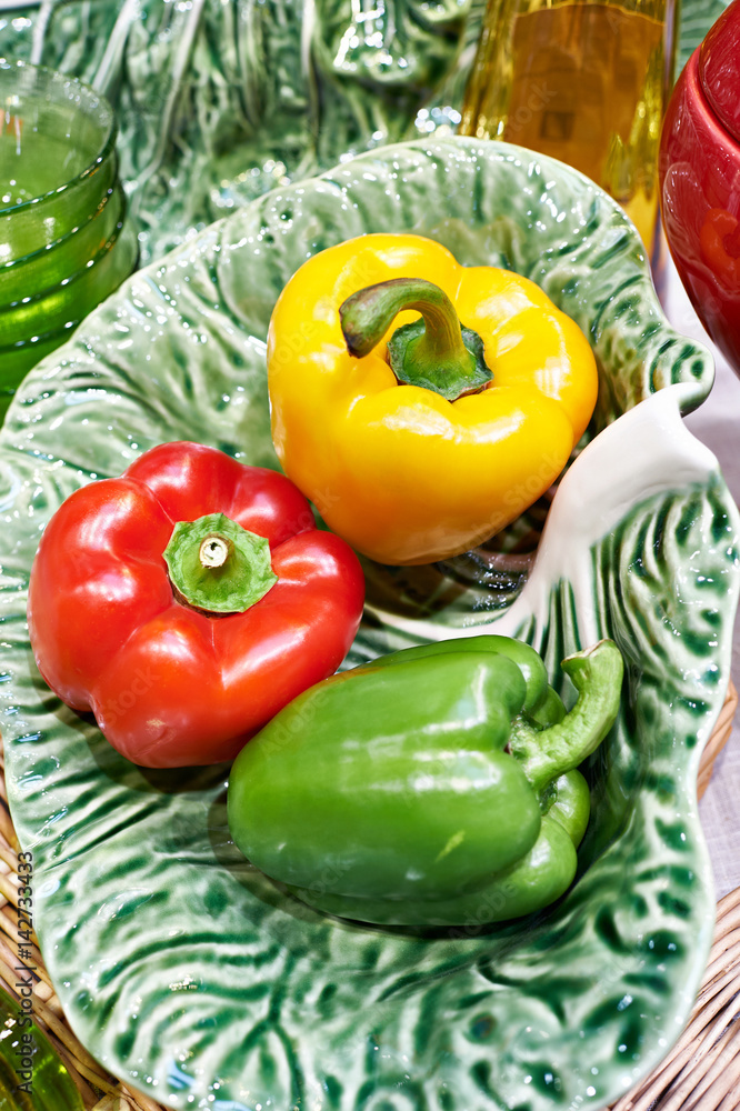 Bell peppers on plate on green cabbage leaf Bell peppers on plate on green cabbage leaf