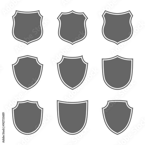 Shield shape icons set. Gray label signs isolated on white background. Symbol of protection, arms, security, safety. Flat retro style design. Element vintage heraldic emblem Vector illustration