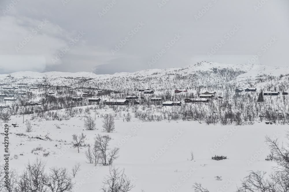 Small snow covered houses in the norwegian mountains 