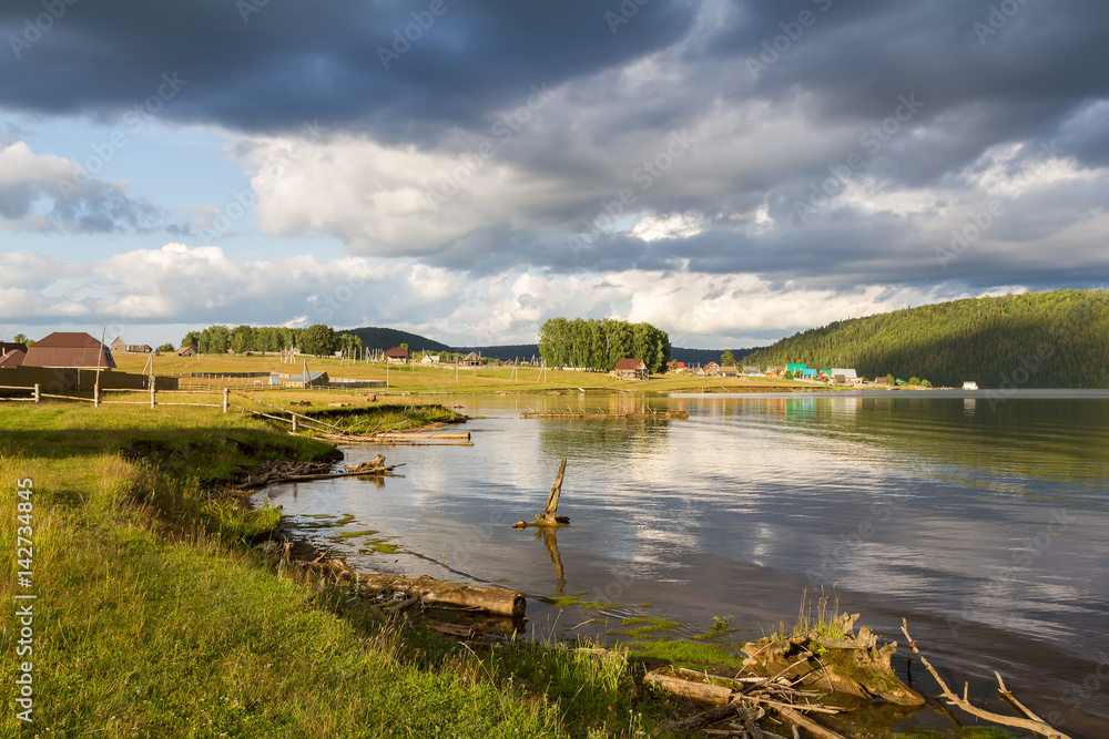 Obraz premium The village by the pond.