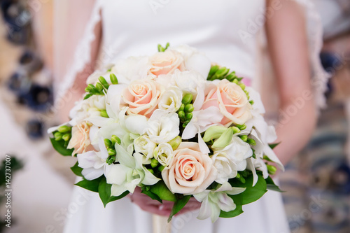 Beautiful wedding bouquet of flowers in bride   s hands