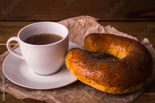 Poppy bun and coffee on a wooden background