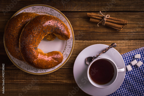 Poppy bun and coffee on a wooden background photo