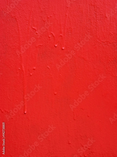 Red metal texture with a roughness and drops of paint surface. Grunge urban background. © koralstory