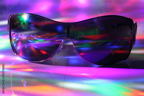 Light show and sunglasses/ Colourful lights and black shades.