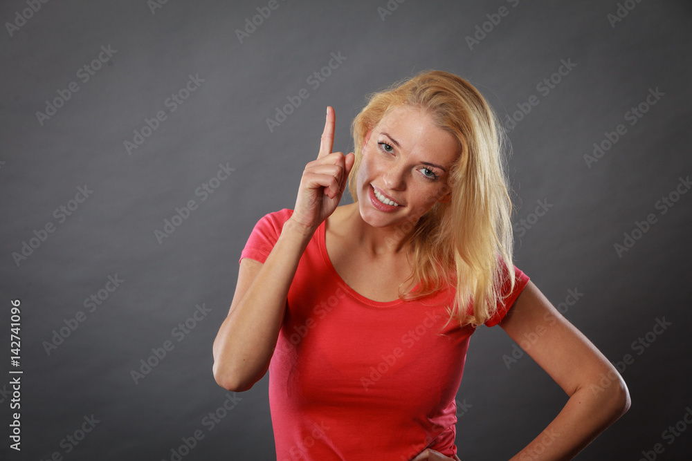 Fototapeta premium Happy woman pointing up with finger