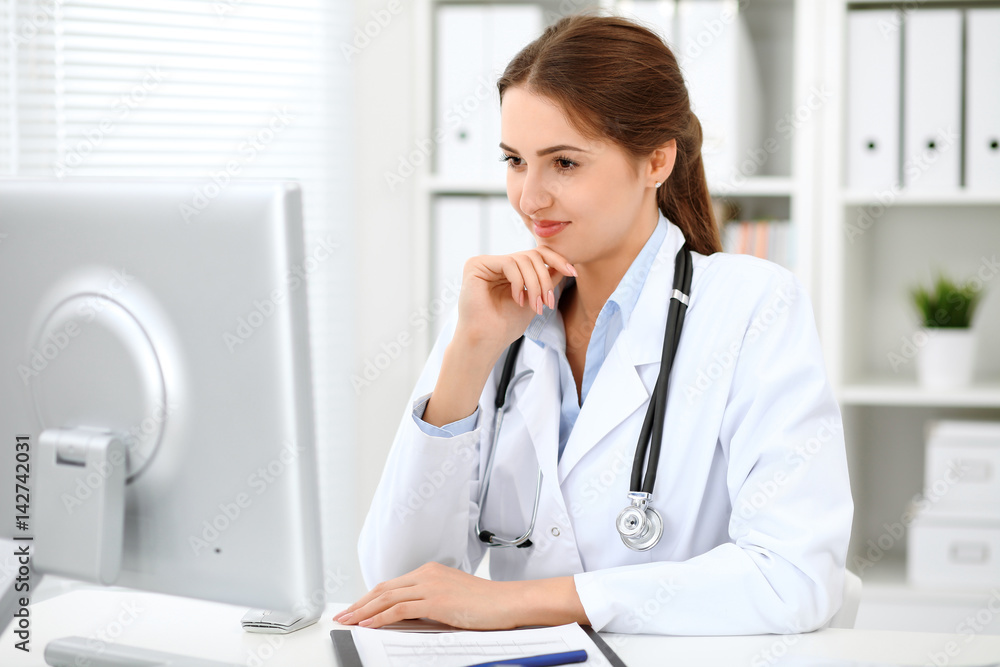 Latin american doctor woman standing with arms crossed and smiling at hospital. Physician ready to examine patient. Health care, insurance and help concept. Physician ready to examine patient Latin american doctor woman standing with arms crossed and smiling at hospital. Physician ready to examine patient. Health care, insurance and help concept. Physician ready to examine patient