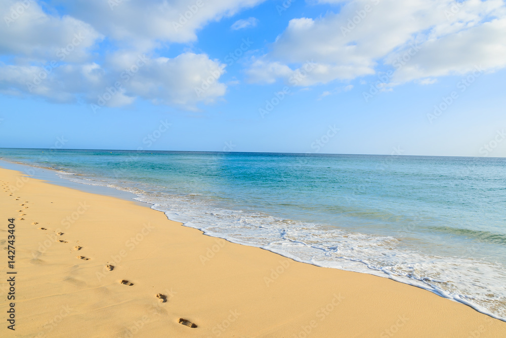 Footprints in golden sand beach on Jandia peninsula, Morro Jable, Fuerteventura, Canary Islands, Spain