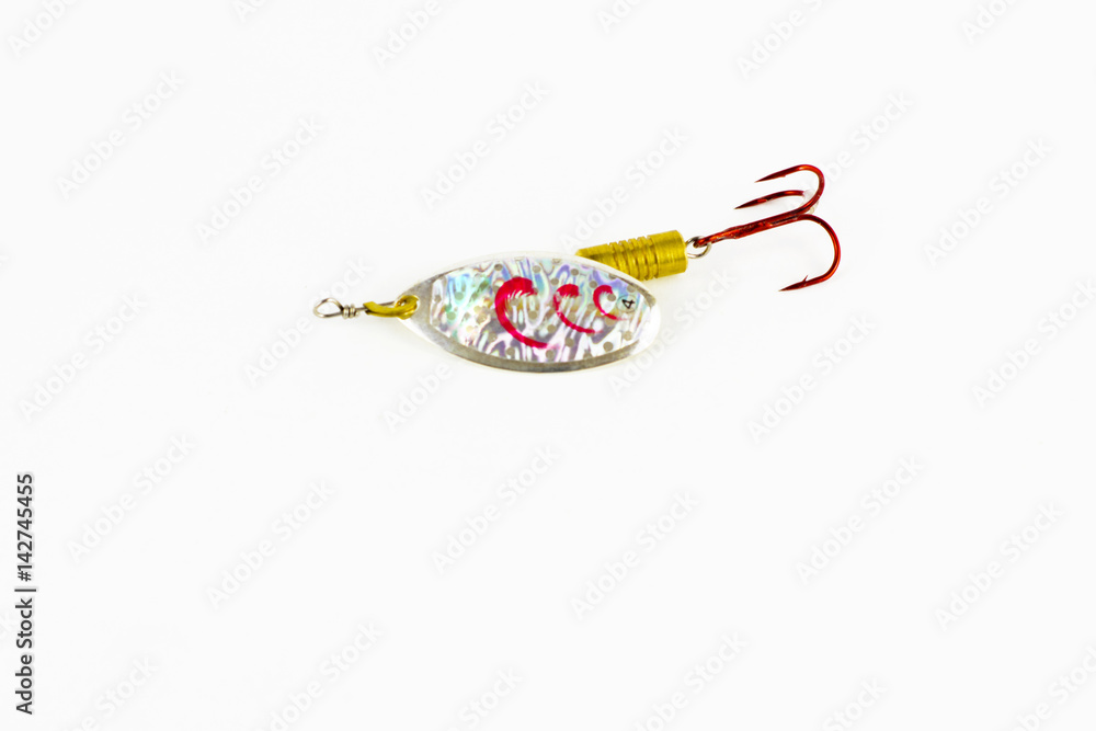 Exhibition of pirated copies of fishing metal spoon baits. Bait for fishing in the shape of a spoon with a hook on a white background Exhibition of pirated copies of fishing metal spoon baits. Bait for fishing in the shape of a spoon with a hook on a white background