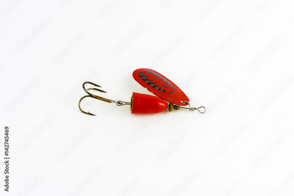 Exhibition of pirated copies of fishing metal spoon baits. Bait for fishing in the shape of a spoon with a hook on a white background Exhibition of pirated copies of fishing metal spoon baits. Bait for fishing in the shape of a spoon with a hook on a white background