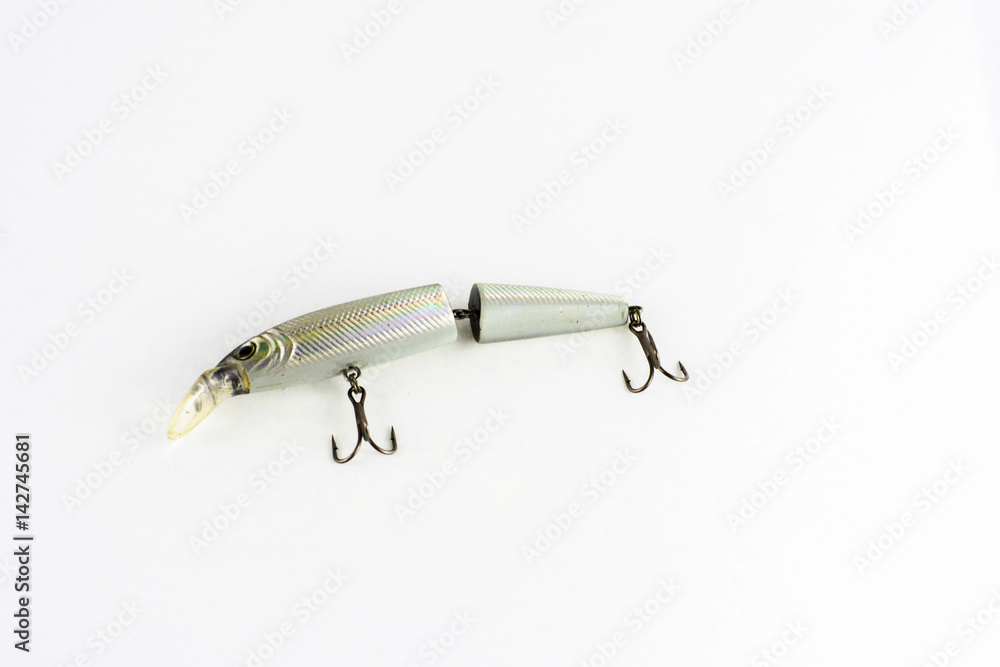 Exhibition of pirated copies of fishing metal spoon baits. Bait for fishing in the shape of a spoon with a hook on a white background Exhibition of pirated copies of fishing metal spoon baits. Bait for fishing in the shape of a spoon with a hook on a white background
