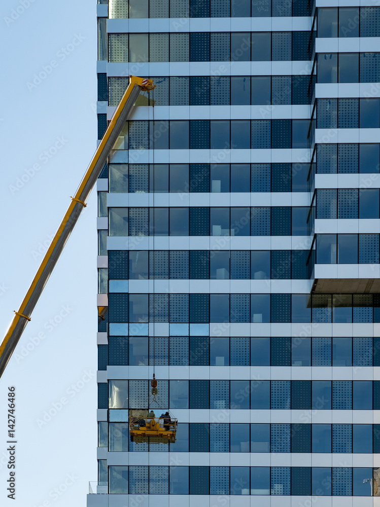custom made wallpaper toronto digitalWindow cleaning or house renovation. Workers in a building cradle, on a high-rise building.