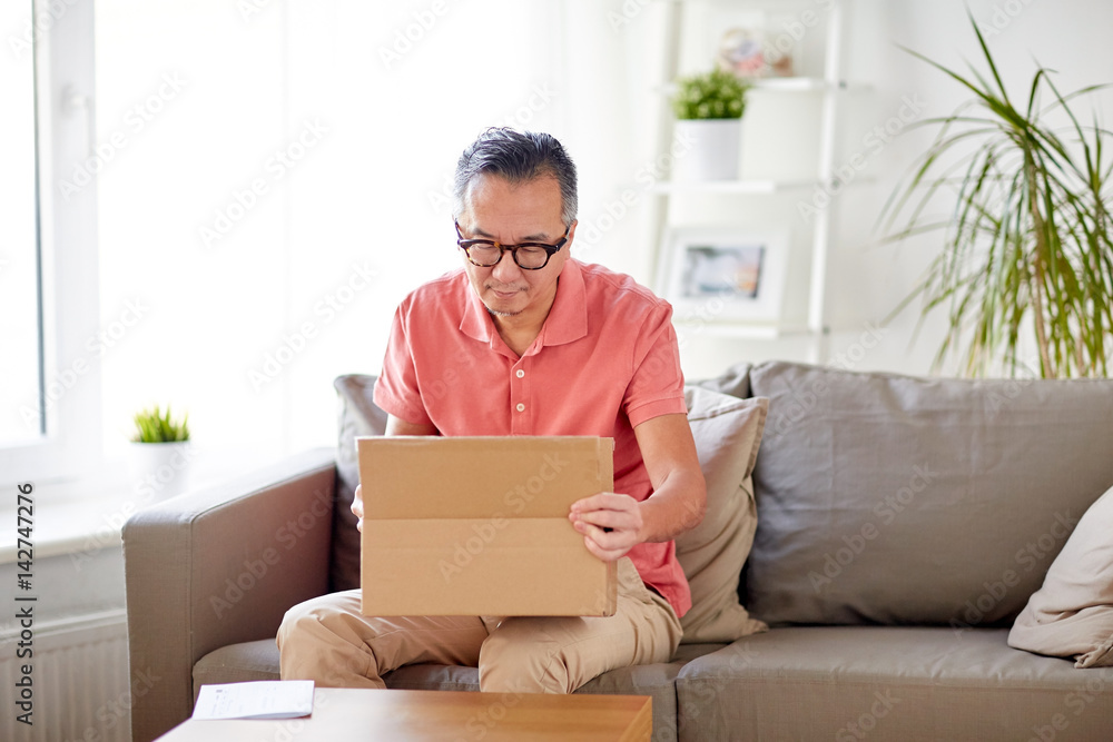man opening parcel box at home man opening parcel box at home