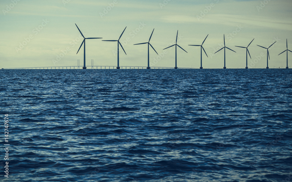 Fototapeta premium Wind turbines power generator farm along coast sea