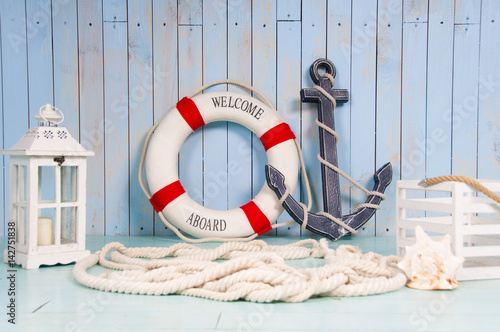 Decor in the style of sea travel. Anchor and lifebuoy, lantern