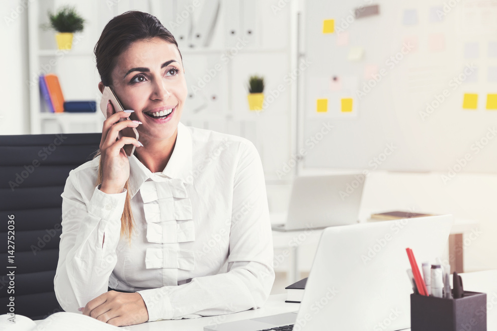 Cheerful brown haired businesswoman on phone Cheerful brown haired businesswoman on phone