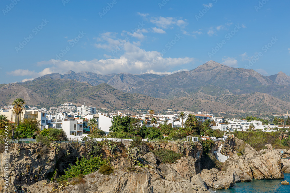 View of a mediterranean coast with houses and mountains in the background, Spain