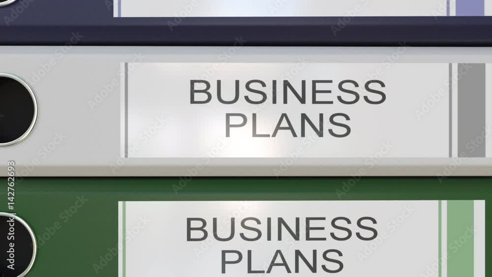 Vertical stack of multicolor office binders with Business plans tags different years Vertical stack of multicolor office binders with Business plans tags different years
