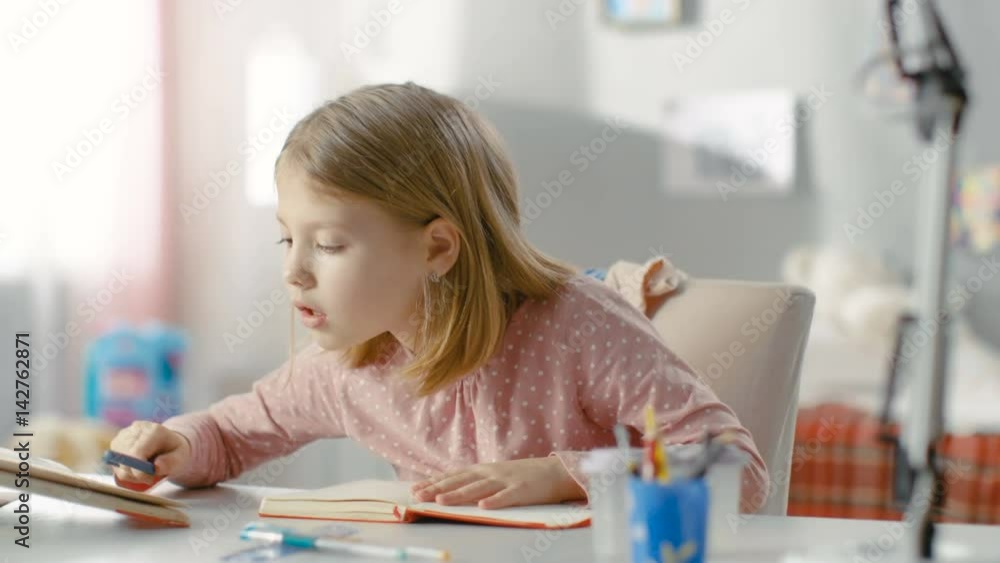 Smart Little Girl Does Homework in Her Room. Shot on RED EPIC-W 8K Helium Cinema Camera. Smart Little Girl Does Homework in Her Room. Shot on RED EPIC-W 8K Helium Cinema Camera.