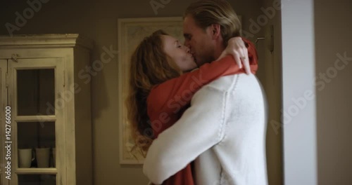 Attractive young couple making out kissing and sharing intimate moment hugging each other 