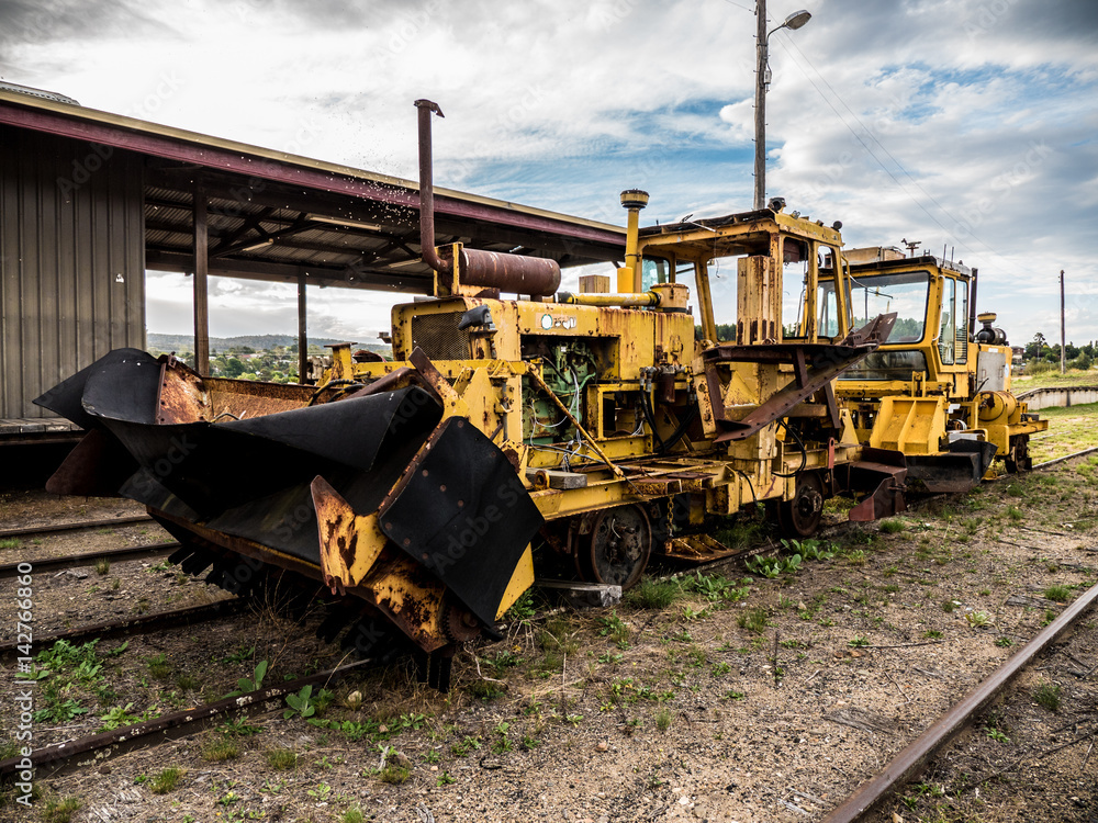 Old rusty train track ballast sweeper