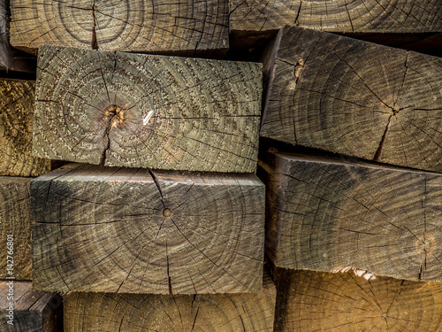 Wooden train sleepers stacked in a pile photo