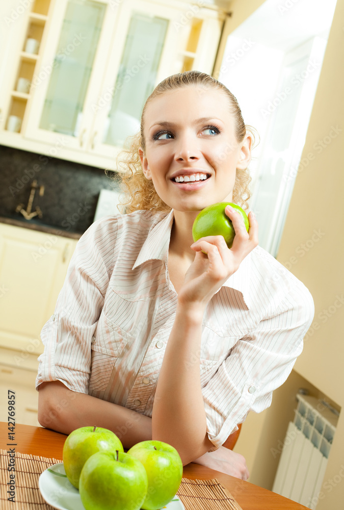 Young happy smiling woman with apple, at home Young happy smiling woman with apple, at home