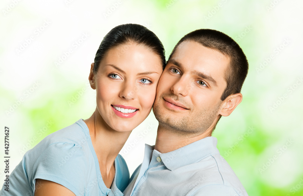 Portrait of young smiling couple, outdoors Portrait of young smiling couple, outdoors