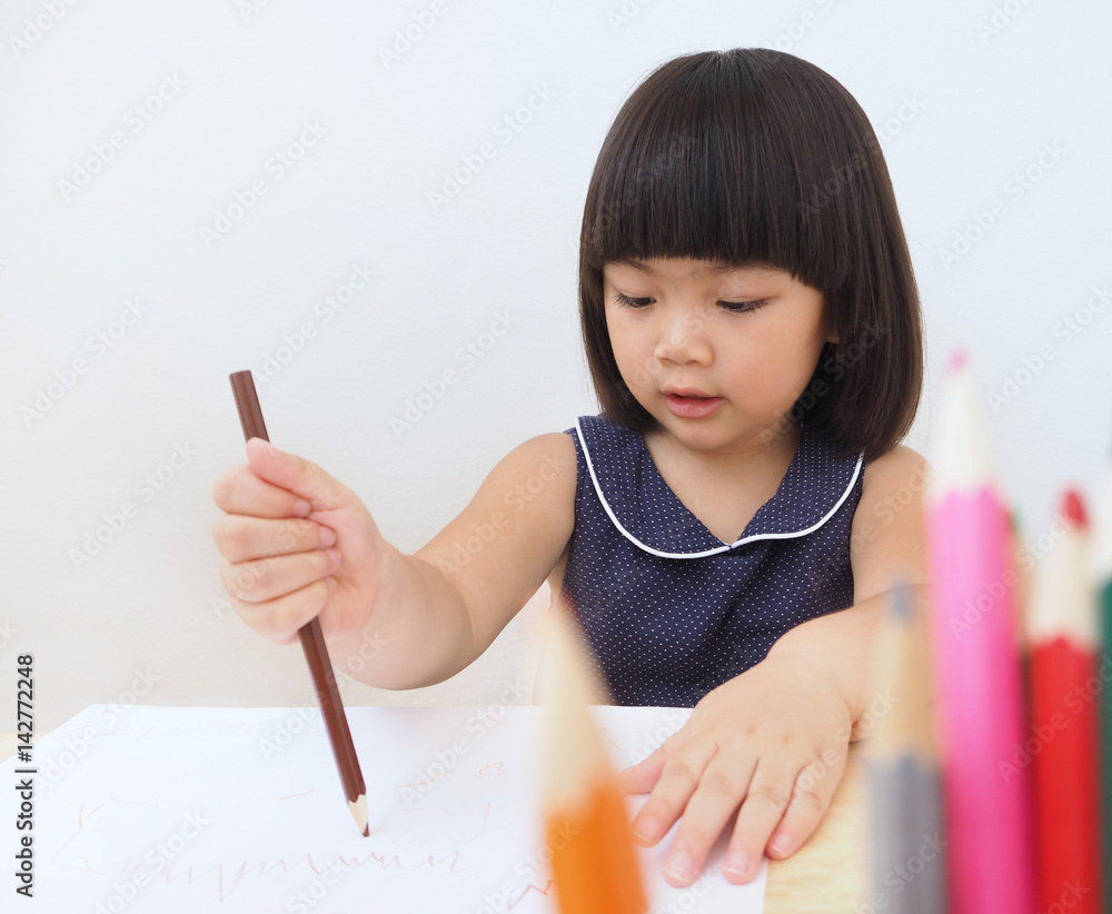 Happy asian kid girl drawing with color pencil, Child learning and playing at home Happy asian kid girl drawing with color pencil, Child learning and playing at home