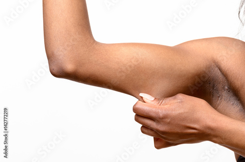 African young woman pinching her arm