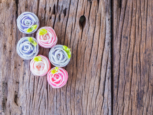 colorful candy with rose shaped. "A-lua or Allure" Thai handmade candy, sweet dessert on the wood table.