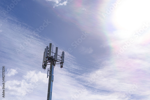 Cell phone telecommunication tower on blue sky and amazing clouds background, Melbourne, Australia.