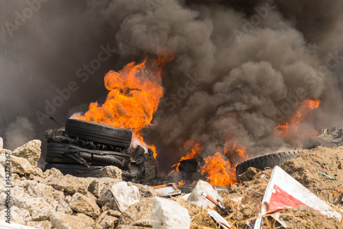 Wallpaper Mural Burning rubber tires creating big black smoke and pollution. Torontodigital.ca