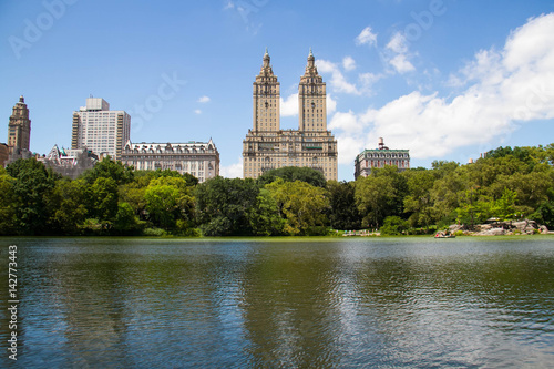 Lake and trees at Central Park and buildings in Manhattan, New York