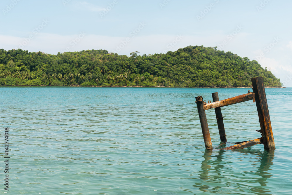weathered steel docking part on a jetty against background of bright blue caribbean sea weathered steel docking part on a jetty against background of bright blue caribbean sea