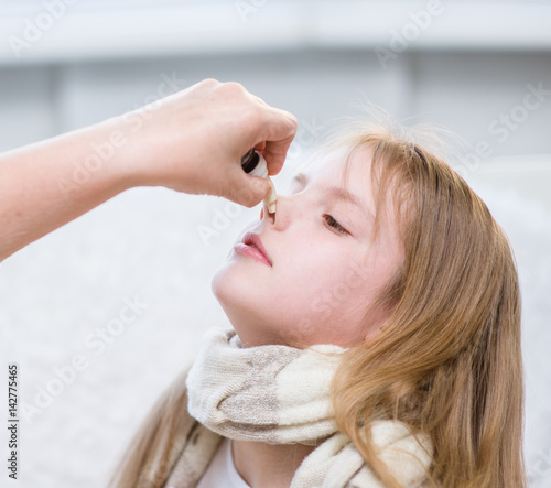 mother medication drips into the nose girl