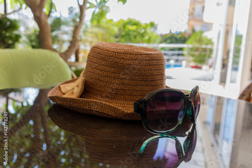 Still life with hat and sun glasses.