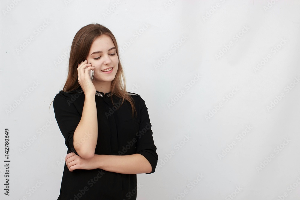 Young Businesswoman on the cell phone isolated on a white background Young Businesswoman on the cell phone isolated on a white background