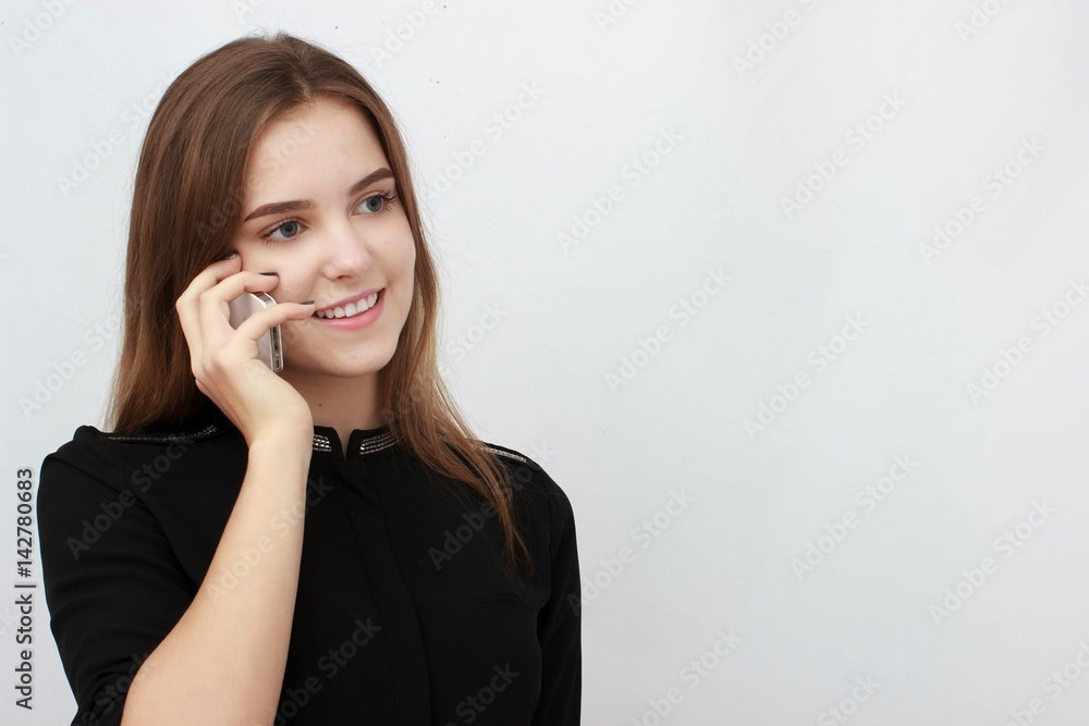 Young Businesswoman on the cell phone isolated on a white background Young Businesswoman on the cell phone isolated on a white background
