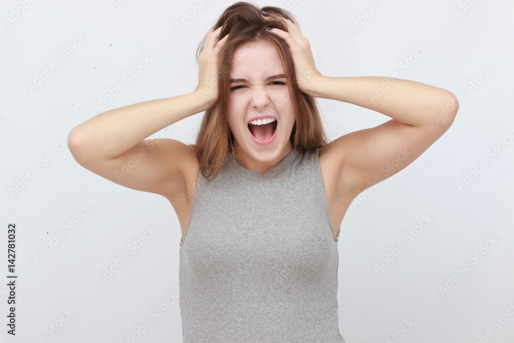 Young woman has headache, isolated on gray background Young woman has headache, isolated on gray background